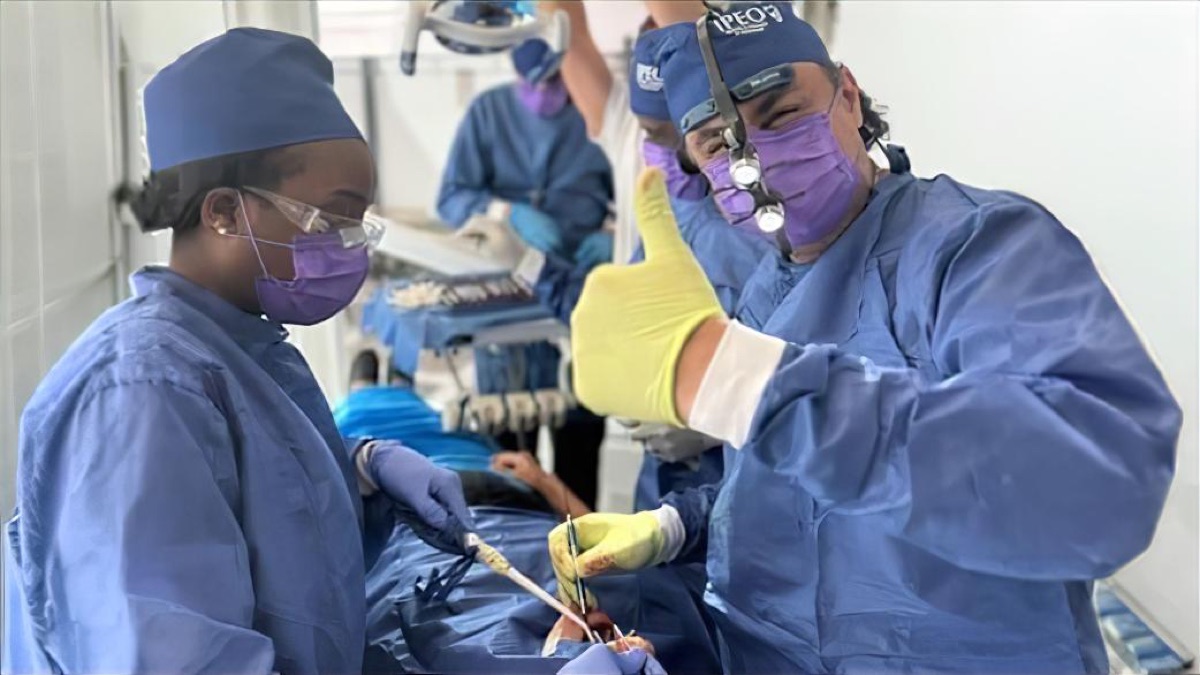Misch faculty supervising an attendee during live implant surgery