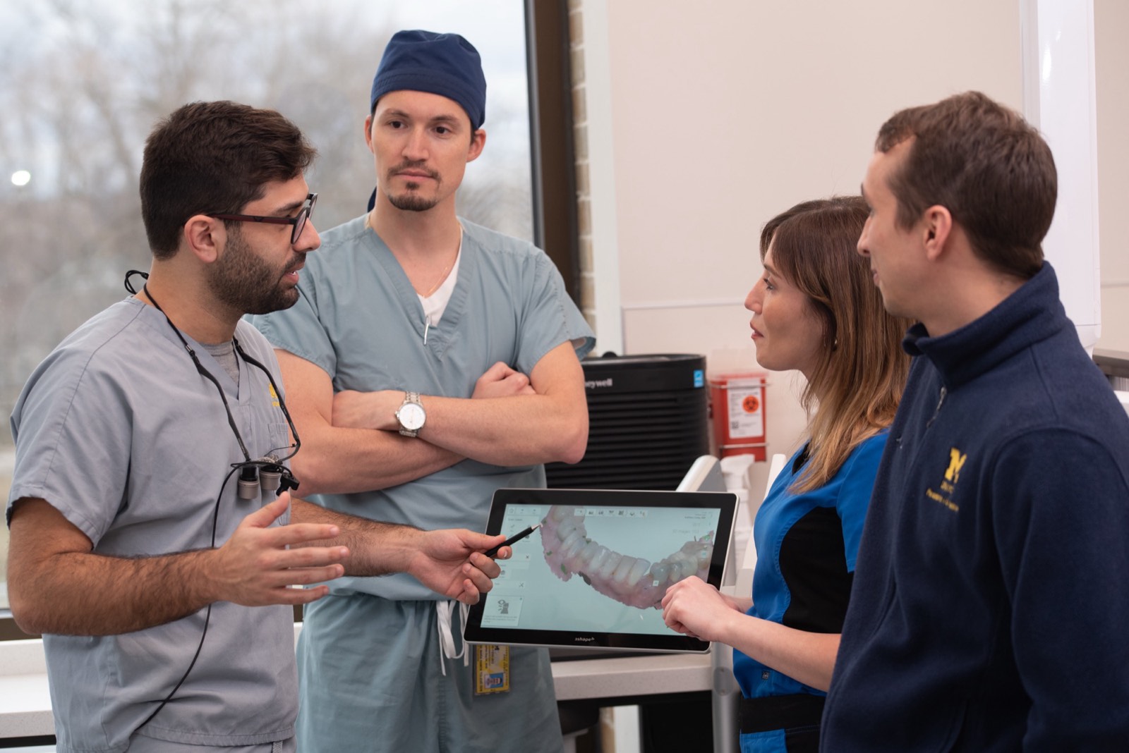 A Misch educator mentoring a clinician at the surgical bench